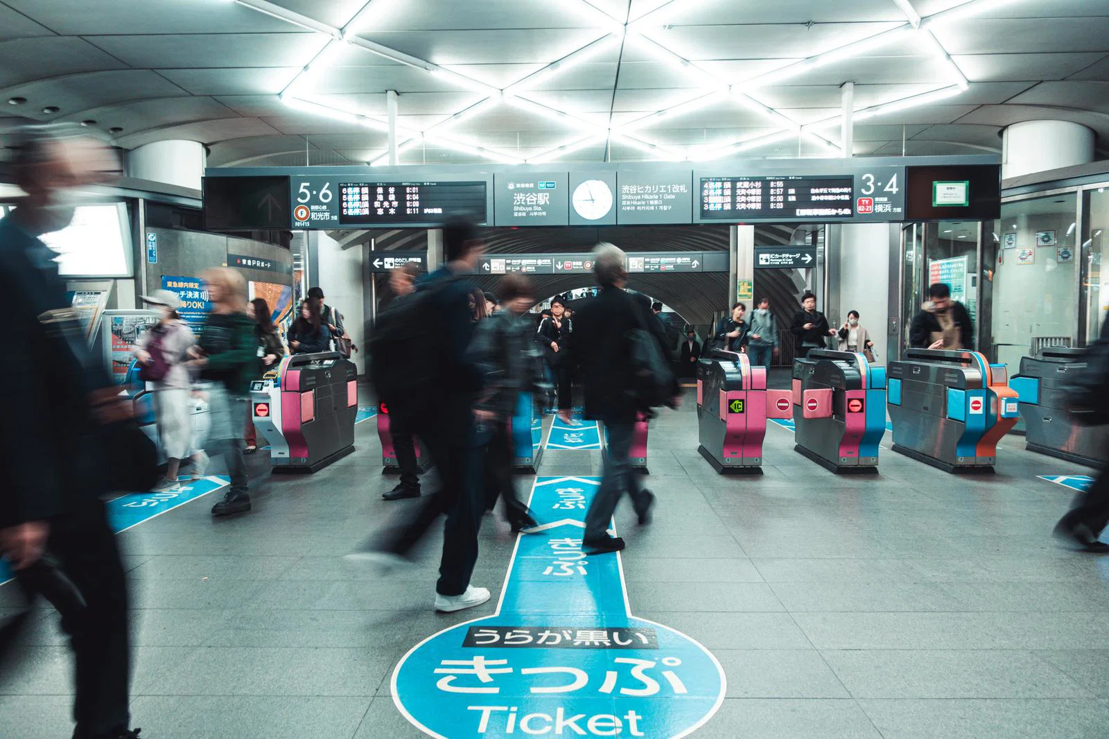 Passengers passing through automatic ticket gates at Shibuya Station